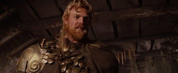 Movie still from “Willow” (1988), directed by Ron Howard – A person with a beard wearing a costume; Close Up shot, Low angle