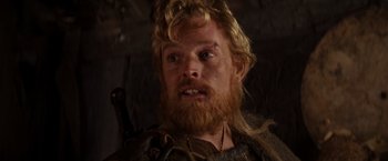 Movie still from “Willow” (1988), directed by Ron Howard – A person with long hair and a beard; Close Up shot, Over the shoulder angle