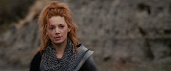 Movie still from “Willow” (1988), directed by Ron Howard – A woman with red curly hair wearing a gray scarf; Close Up shot, Low angle