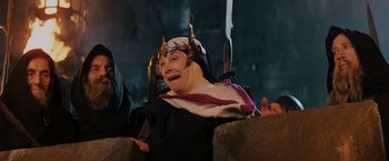 Movie still from “Willow” (1988), directed by Ron Howard – A person wearing a helmet with horns on it; Medium shot, Low angle