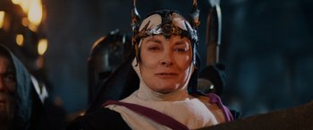 Movie still from “Willow” (1988), directed by Ron Howard – A woman wearing a helmet with a crown on her head; Close Up shot, Low angle