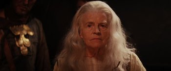 Movie still from “Willow” (1988), directed by Ron Howard – An old woman with long white hair looking at the camera; Close Up shot, Low angle