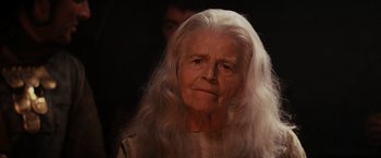 Movie still from “Willow” (1988), directed by Ron Howard – An old woman with long white hair looking at the camera; Close Up shot, Low angle