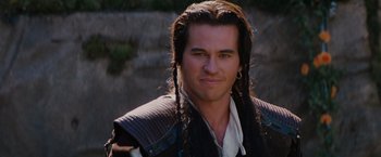 Movie still from “Willow” (1988), directed by Ron Howard – A person with long black hair; Close Up shot, Over the shoulder angle