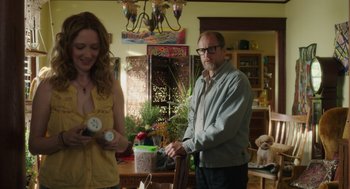 Movie still from “Wilson” (2017), directed by Craig Johnson – A man and a woman standing next to each other in a room; Medium shot, Over the shoulder angle