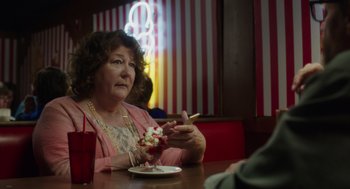Movie still from “Wilson” (2017), directed by Craig Johnson – An older woman sitting in front of a bowl of ice cream; Medium shot, Over the shoulder angle