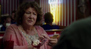 Movie still from “Wilson” (2017), directed by Craig Johnson – A woman sitting at a table looking at her cell phone; Close Up shot, Over the shoulder angle