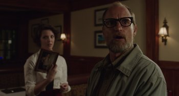 Movie still from “Wilson” (2017), directed by Craig Johnson – A man and a woman are standing in a living room; Medium shot, Over the shoulder angle