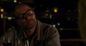 Movie still from “Wilson” (2017), directed by Craig Johnson – A person sitting in front of a wine glass; Close Up shot, Over the shoulder angle