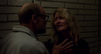 Movie still from “Wilson” (2017), directed by Craig Johnson – A man and a woman standing next to a brick wall; Close Up shot, Low angle