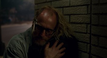 Movie still from “Wilson” (2017), directed by Craig Johnson – A man with long blond hair hugging another man; Close Up shot, Over the shoulder angle