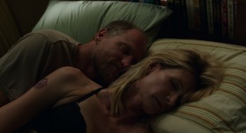 Movie still from “Wilson” (2017), directed by Craig Johnson – A man and a woman laying in bed together; Close Up shot, Overhead angle