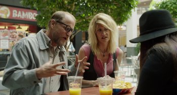 Movie still from “Wilson” (2017), directed by Craig Johnson – A man and a woman sitting at a table with drinks; Medium shot, Over the shoulder angle