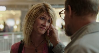 Movie still from “Wilson” (2017), directed by Craig Johnson – A woman holding a man's ear while he looks at her face; Close Up shot, Over the shoulder angle