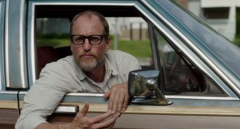 Movie still from “Wilson” (2017), directed by Craig Johnson – A man sitting in the driver's seat of a car looking out of the window; Close Up shot, Low angle