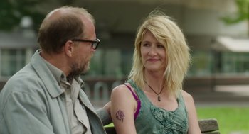 Movie still from “Wilson” (2017), directed by Craig Johnson – A man standing next to a woman in a green dress; Close Up shot, Over the shoulder angle