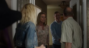 Movie still from “Wilson” (2017), directed by Craig Johnson – A group of people standing in a living room talking; Medium shot, Over the shoulder angle