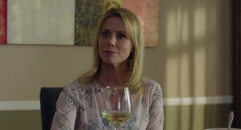 Movie still from “Wilson” (2017), directed by Craig Johnson – A woman sitting in front of a glass of wine; Close Up shot, Over the shoulder angle