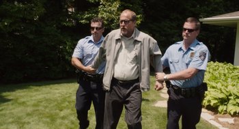 Movie still from “Wilson” (2017), directed by Craig Johnson – A group of men standing on top of a lush green field; Wide shot, Low angle