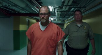 Movie still from “Wilson” (2017), directed by Craig Johnson – A man in an orange shirt is walking down a hallway; Medium shot, Low angle