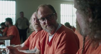 Movie still from “Wilson” (2017), directed by Craig Johnson – Two men in orange shirts are sitting in a room; Close Up shot, Over the shoulder angle