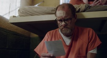 Movie still from “Wilson” (2017), directed by Craig Johnson – A man with a bandage on his head reads a letter; Close Up shot, Over the shoulder angle