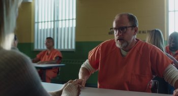 Movie still from “Wilson” (2017), directed by Craig Johnson – A man in an orange shirt is shaking hands with another man in an orange shirt; Medium shot, Over the shoulder angle