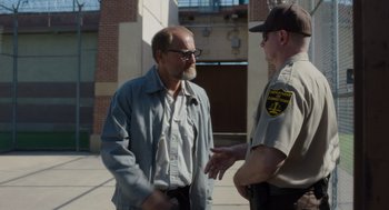 Movie still from “Wilson” (2017), directed by Craig Johnson – A man talking to a police officer on the street; Medium shot, Over the shoulder angle