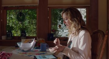 Movie still from “Wilson” (2017), directed by Craig Johnson – A woman sitting at a table with a cup of coffee; Medium shot, Over the shoulder angle