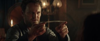 Movie still from “Winchester” (2018), directed by Michael Spierig – A person holding something in his hands; Close Up shot, Low angle