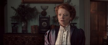 Movie still from “Winchester” (2018), directed by Michael Spierig – A woman with red curly hair wearing a dress; Close Up shot, Low angle