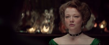 Movie still from “Winchester” (2018), directed by Michael Spierig – A person wearing a green dress; Close Up shot, Over the shoulder angle
