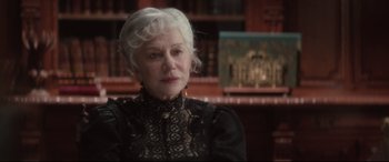 Movie still from “Winchester” (2018), directed by Michael Spierig – An older woman with white hair wearing a black dress; Close Up shot, Over the shoulder angle