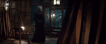 Movie still from “Winchester” (2018), directed by Michael Spierig – A woman in a black dress looking out of a window; Wide shot, High angle