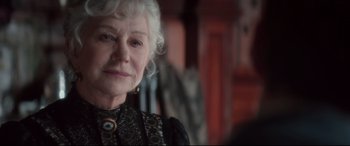 Movie still from “Winchester” (2018), directed by Michael Spierig – An older woman with white hair wearing a black dress; Close Up shot, Over the shoulder angle