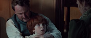 Movie still from “Winchester” (2018), directed by Michael Spierig – A man and a boy sitting in a room; Close Up shot, Over the shoulder angle