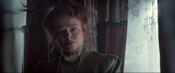 Movie still from “Winchester” (2018), directed by Michael Spierig – A person wearing a green jacket; Close Up shot, Low angle