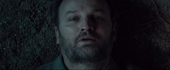 Movie still from “Winchester” (2018), directed by Michael Spierig – A person with a beard; Close Up shot, Overhead angle