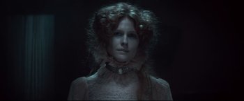 Movie still from “Winchester” (2018), directed by Michael Spierig – A woman in a white dress and a necklace; Close Up shot, Low angle