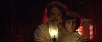 Movie still from “Winchester” (2018), directed by Michael Spierig – A woman and a child are looking at a candle; Close Up shot, Low angle