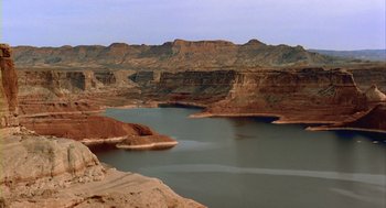 Movie still from “Winged Migration” (2001), directed by Jacques Cluzaud – A view of a body of water with mountains in the background; Extreme Wide shot, High angle