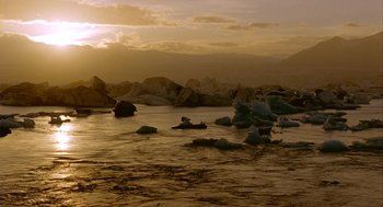 Movie still from “Winged Migration” (2001), directed by Jacques Cluzaud – A body of water that has some rocks in the water; Extreme Wide shot, Low angle