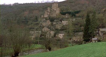 Movie still from “Winged Migration” (2001), directed by Jacques Cluzaud – An old stone village sits on a hillside; Extreme Wide shot, High angle