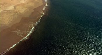 Movie still from “Winged Migration” (2001), directed by Jacques Cluzaud – An aerial view of a body of water; Extreme Wide shot, Overhead angle