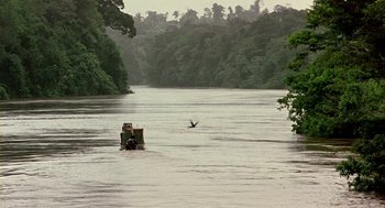 Movie still from “Winged Migration” (2001), directed by Jacques Cluzaud – A person in a boat in the middle of a river; Extreme Wide shot, High angle