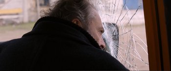 Movie still from “Winter Sleep” (2014), directed by Nuri Bilge Ceylan – An older man looking out of a broken window; Close Up shot, Over the shoulder angle