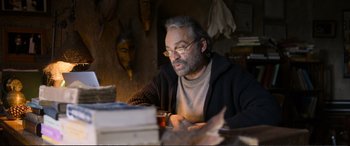 Movie still from “Winter Sleep” (2014), directed by Nuri Bilge Ceylan – A man sitting at a table with a glass of wine; Close Up shot, Over the shoulder angle