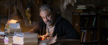 Movie still from “Winter Sleep” (2014), directed by Nuri Bilge Ceylan – An older man sitting at a table with a cup of coffee; Medium shot, Low angle