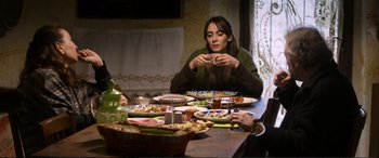 Movie still from “Winter Sleep” (2014), directed by Nuri Bilge Ceylan – A woman sitting at a table with a plate of food on it; Medium shot, High angle