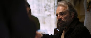 Movie still from “Winter Sleep” (2014), directed by Nuri Bilge Ceylan – An older man sitting in front of a window; Close Up shot, Over the shoulder angle